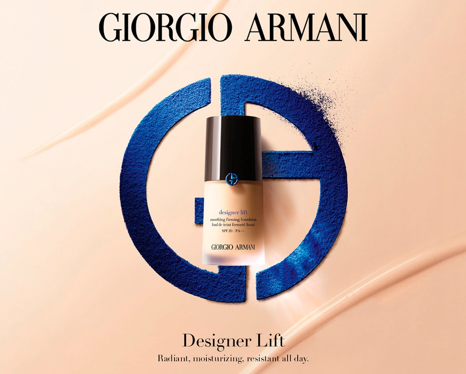 Giorgio Armani foundation bottle displayed over a blue powder logo against a peach background