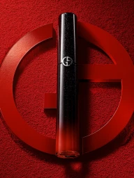 Black and red cosmetic product tube positioned vertically against a red textured background with a circular graphic frame.