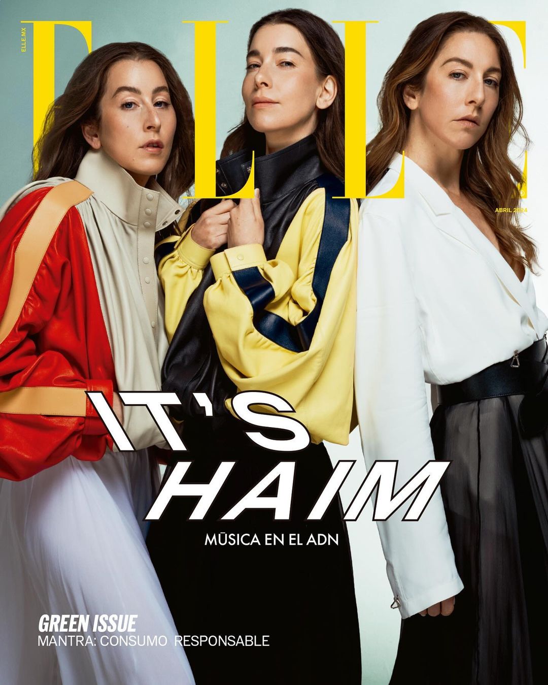 Three women from HAIM band on a magazine cover, posing in stylish color-blocked jackets. ELLE logo, cover text about 'Green Issue'.