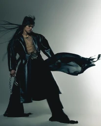 Model in black leather coat holding chain with long hair blowing against grey studio seamless background