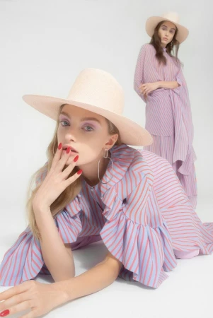 Two female models in striped dresses and wide-brimmed hats against a white background by Cesar Love Alexandre