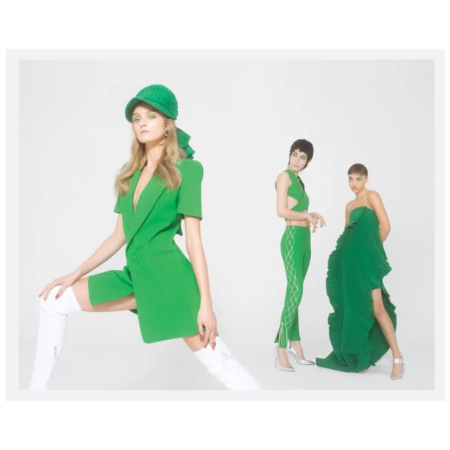Three fashion models in green designer outfits pose in a photo studio against a white backdrop, showcasing modern, high-fashion apparel.