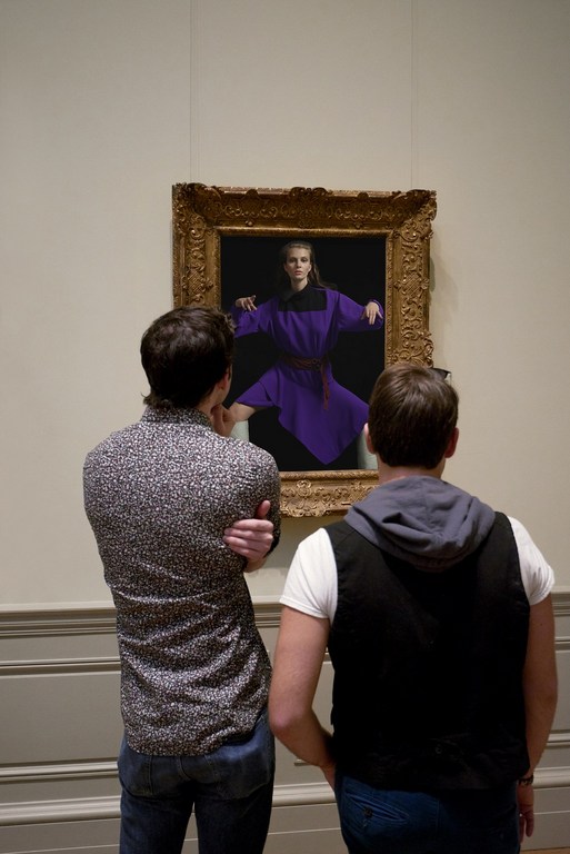 Two men view an art gallery painting of a woman in purple, standing in front of a dark background, in an ornate gold frame.