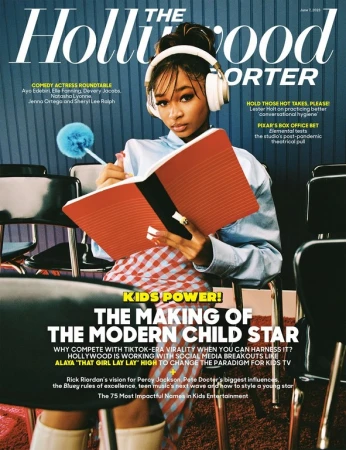 Magazine cover featuring a young adult with headphones, red book, and writing tool, seated among black chairs against a blue background.