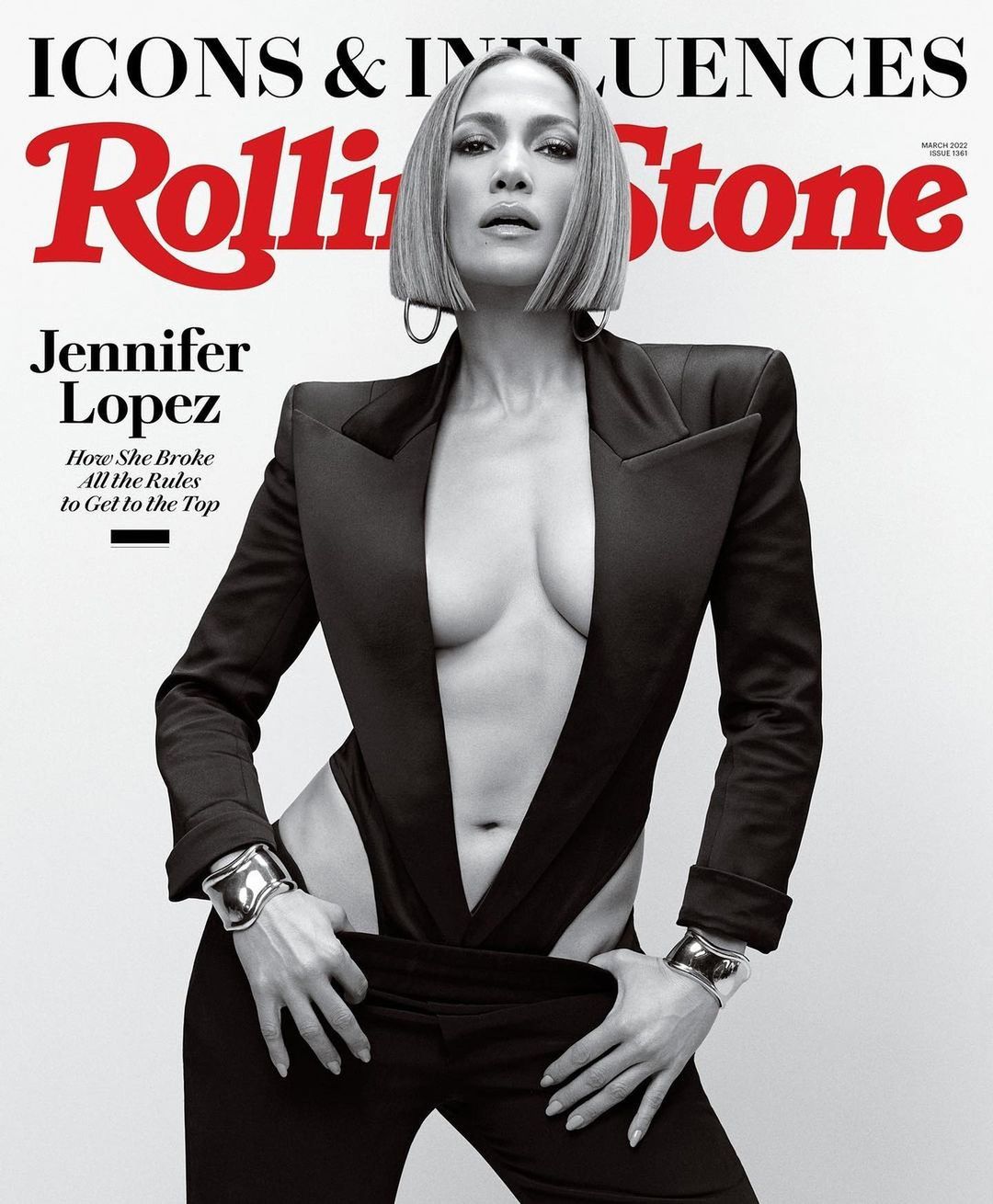 Jennifer Lopez poses on a Rolling Stone magazine cover. She wears a black suit with an open front and bracelets. The cover features the title.