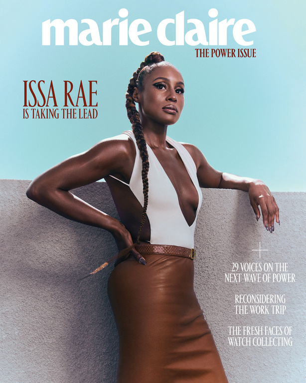 Issa Rae on the cover of Marie Claire's 'The Power Issue', posing in a white top and brown leather skirt against a blue sky backdrop.