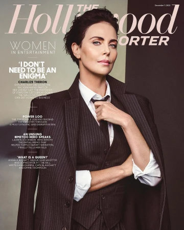 Charlize Theron magazine cover portrait. Hollywood Reporter features actress in pinstripe suit, crisp white shirt, and black tie.
