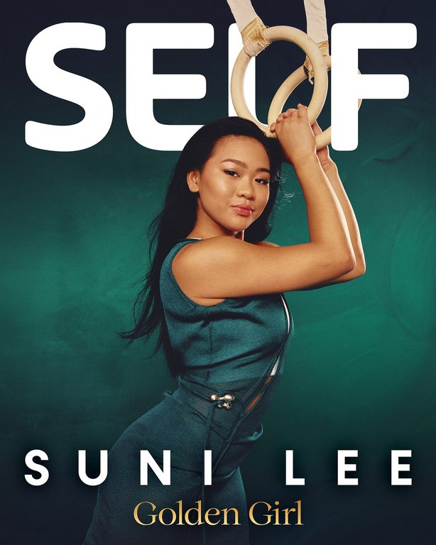 Portrait of gymnast Suni Lee performing on rings against a gradient teal background, as seen on the cover of SELF magazine.
