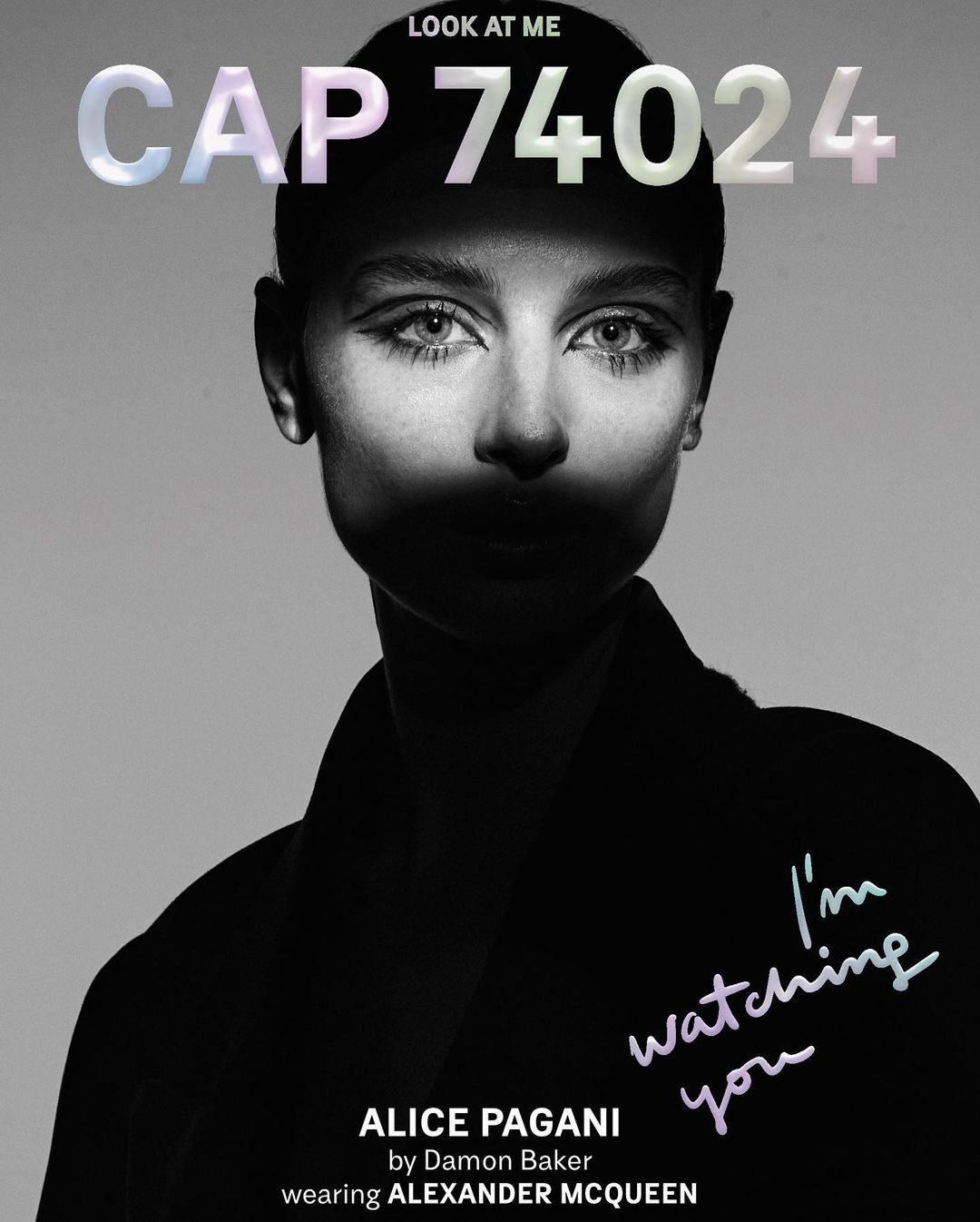 Black-and-white close-up of a model's face with dark eye makeup, paired with large stylized text and fashion branding on a light grey background.
