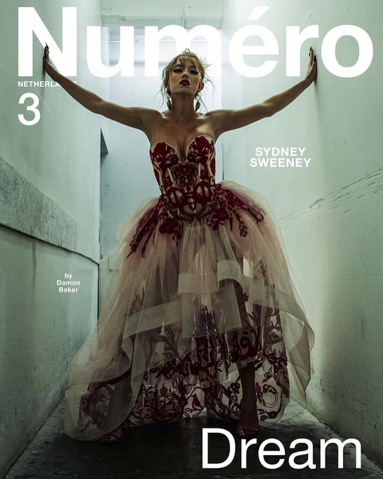 Sydney Sweeney on the cover of Numero Netherlands 3, wearing a strapless red and pink tulle dress, posing in a narrow hallway.