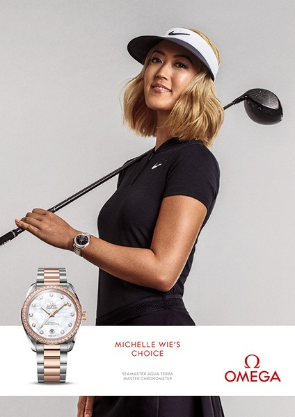 Omega watch advertisement featuring Michelle Wie West, professional golfer, in sports apparel holding a golf club.