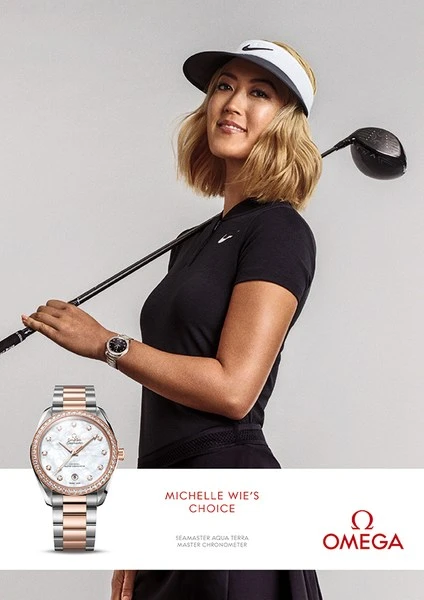 Omega watch advertisement featuring Michelle Wie West, professional golfer, in sports apparel holding a golf club.