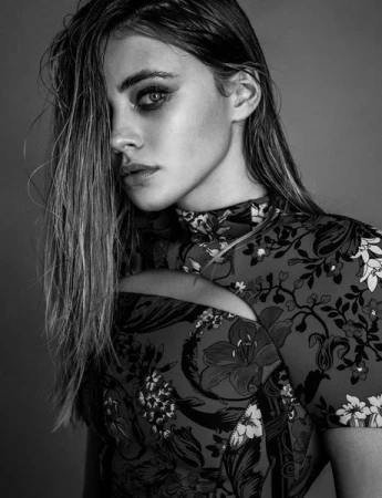 Close-up portrait of a woman with wet hair and smoky eye makeup wearing a floral print top by photographer Damon Baker
