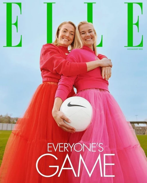 Two women, Elle magazine cover, sport fashion concept. Athletes embrace outdoors wearing tulle skirts, holding soccer ball, sunny sky.
