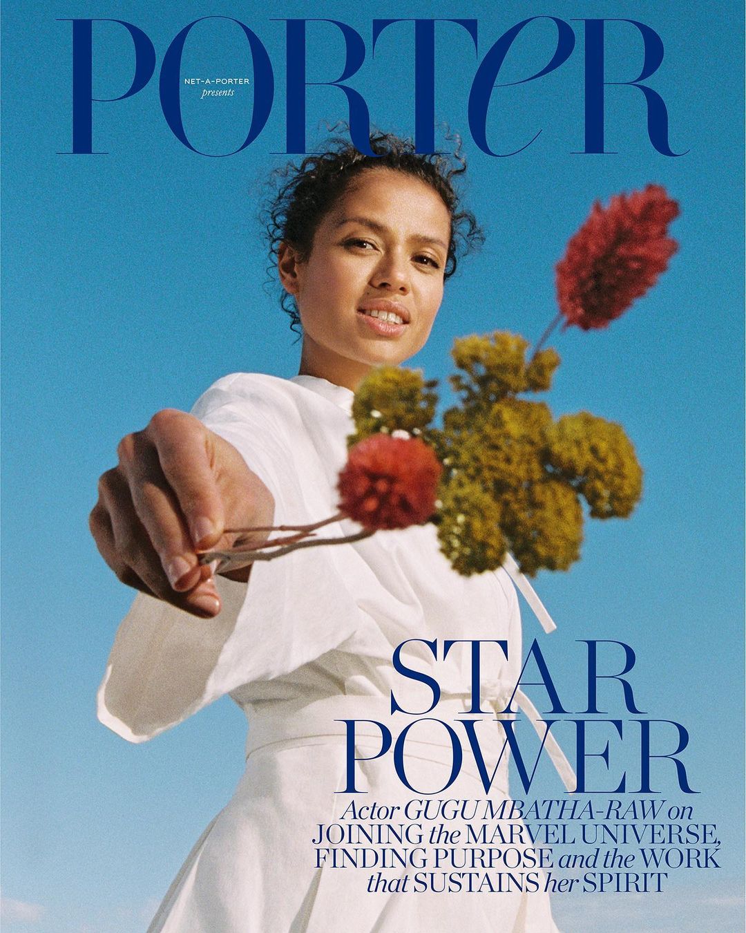 Porter magazine cover featuring Gugu Mbatha-Raw in white dress holding flowers against a blue sky with bold magazine text overlay.