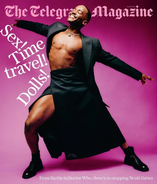 Magazine cover features Ncuti Gatwa in black suit jacket and skirt, smiling against pink backdrop with overlaid text, styled editorial.
