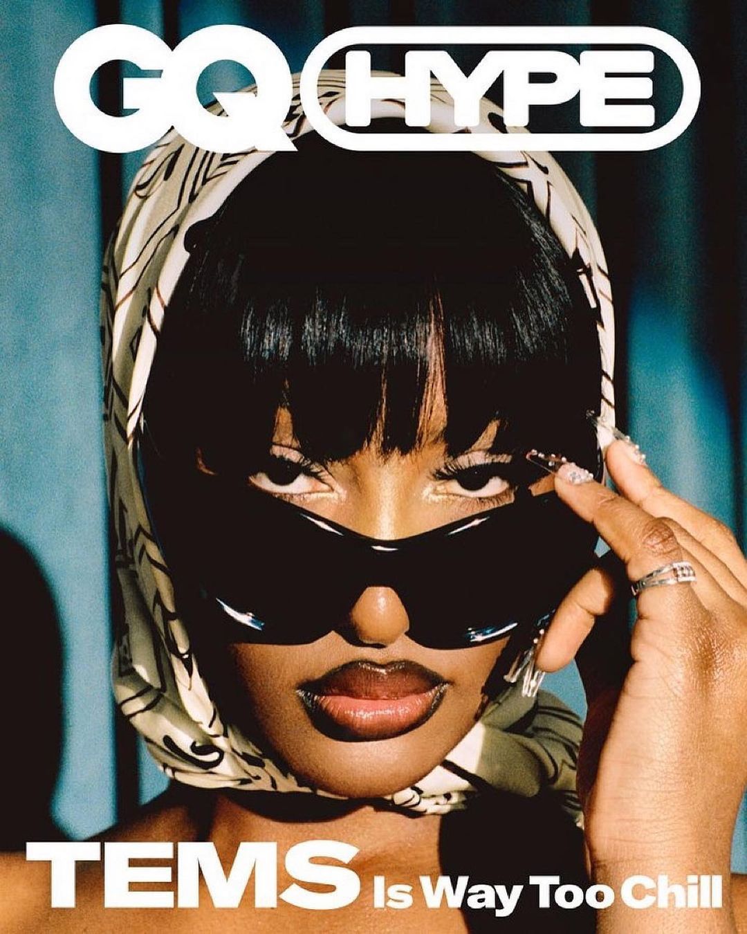 Close-up fashion magazine cover featuring an African-American woman wearing sunglasses and a patterned headscarf, with bold magazine text.