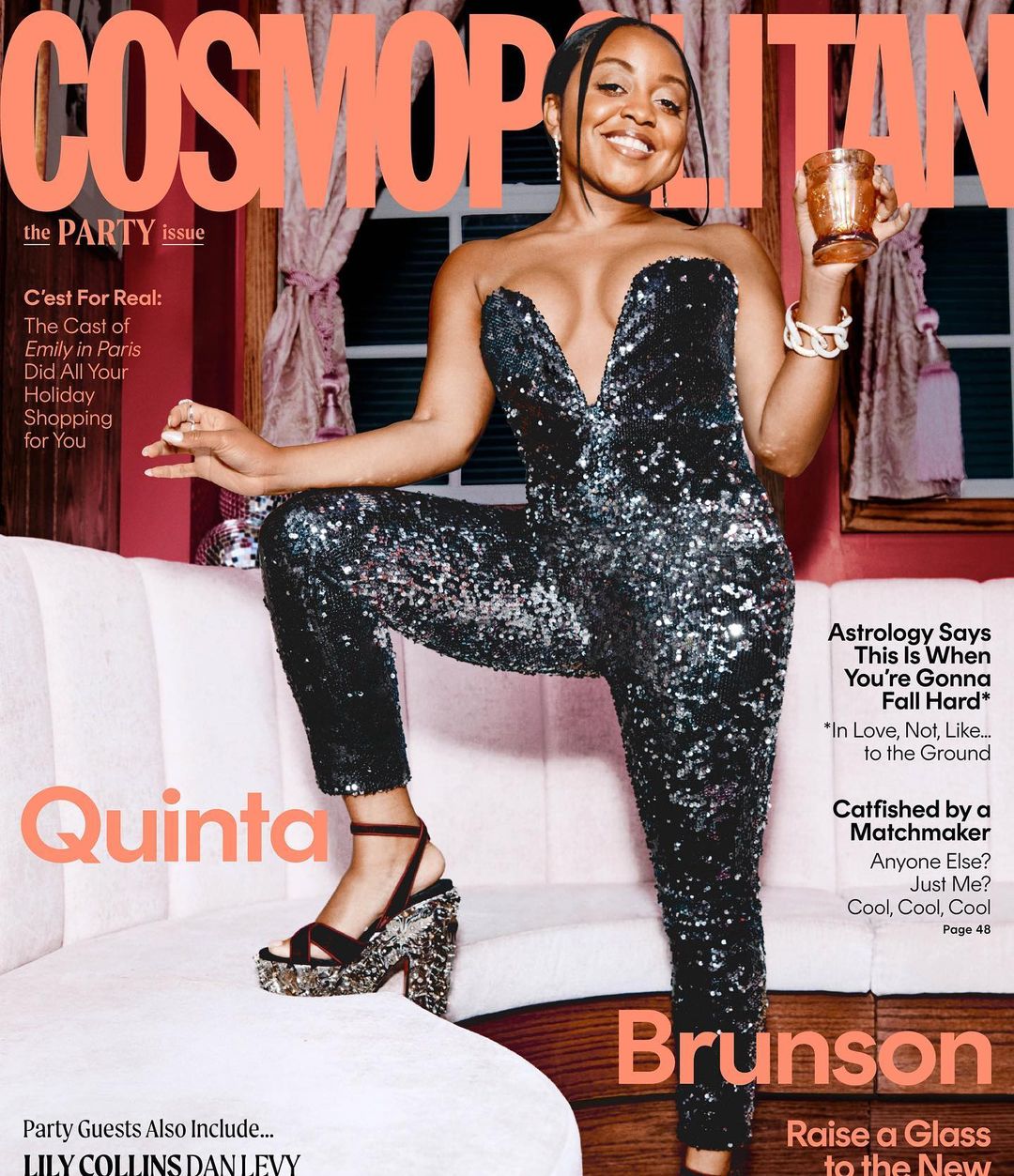 Cosmopolitan magazine cover featuring Quinta Brunson wearing a sparkly jumpsuit, holding a glass, and standing on a white couch.