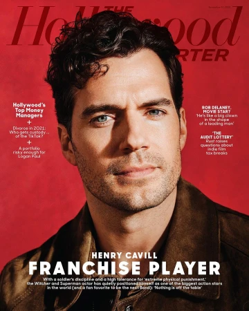 Henry Cavill on The Hollywood Reporter cover, wearing a brown jacket against a red background. Magazine features articles on Hollywood money managers.