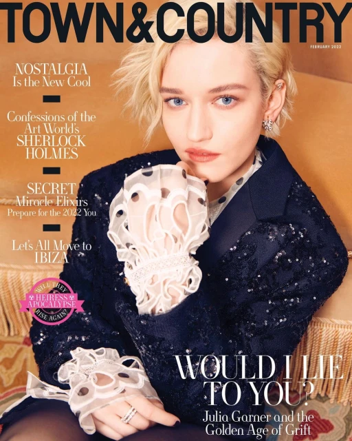 Julia Garner on the cover of Town & Country magazine, February 2022 issue. She wears a sequined jacket and sheer ruffled top.