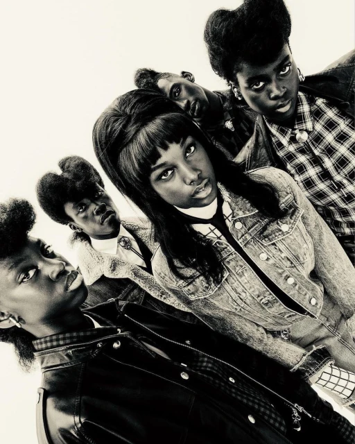 Group of five African American young adults in vintage 90s fashion, posing in a photo studio with medium shot, eye-level angle, and plain background.