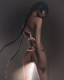 Portrait of a woman with a long dark braided hairstyle wearing a patterned top against a dark moody background