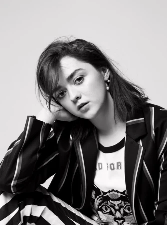 Portrait of Maisie Williams in a striped suit and graphic t-shirt by photographer Kerry Hallihan