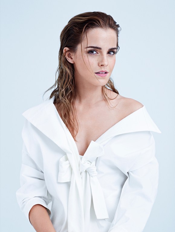Close-up portrait of a young woman with wet hair, wearing a white shirt. The image has a soft, diffused lighting and clean background.