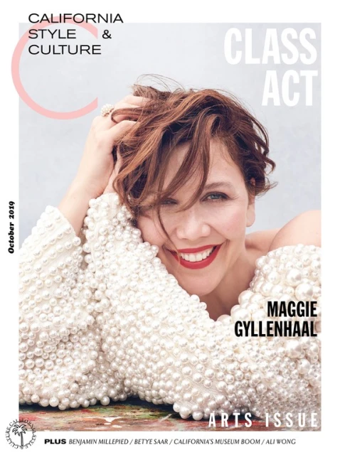Magazine cover featuring Maggie Gyllenhaal with short brown hair, wearing a pearl-covered top, smiling against a neutral gray background.
