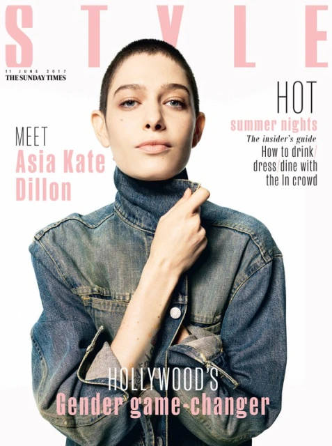 Magazine cover featuring Asia Kate Dillon, an adult, wearing a denim jacket and turtleneck top against a white backdrop with pink text.