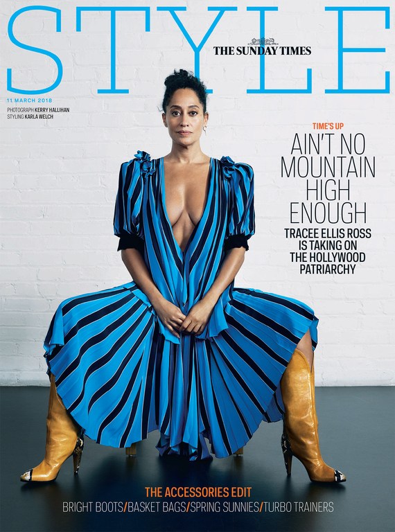 Tracee Ellis Ross poses on the cover of STYLE magazine wearing a striped blue dress and tan boots against a neutral backdrop.