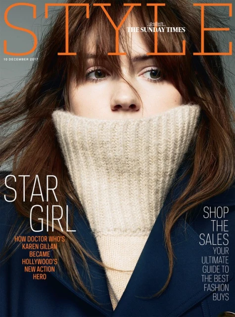 Magazine cover featuring Karen Gillan, styled with a high-neck sweater and a dark coat, against a neutral background with overlaid text.