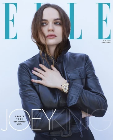 Joey King wearing a black leather jacket against a white studio background for an Elle magazine cover