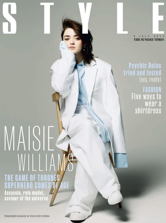 Maisie Williams on Style magazine cover wearing a white suit and light blue shirt, sitting on a wooden chair in a portrait format.