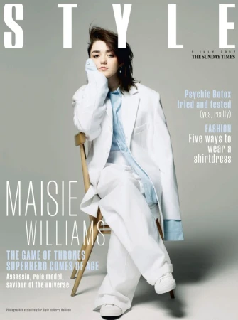 Maisie Williams on Style magazine cover wearing a white suit and light blue shirt, sitting on a wooden chair in a portrait format.