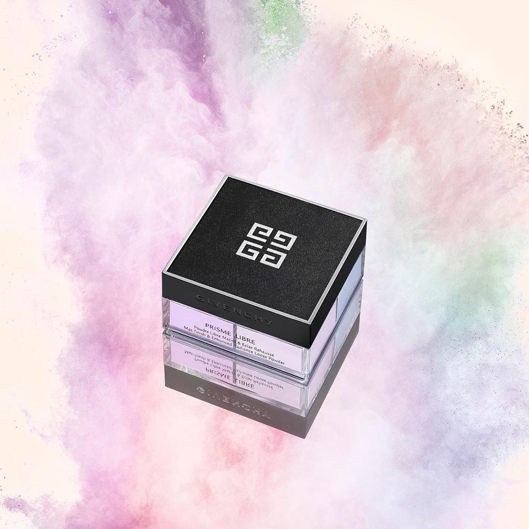 Square cosmetic container of Givenchy Prisme Libre powder on a reflective surface with an ethereal pastel powder background.