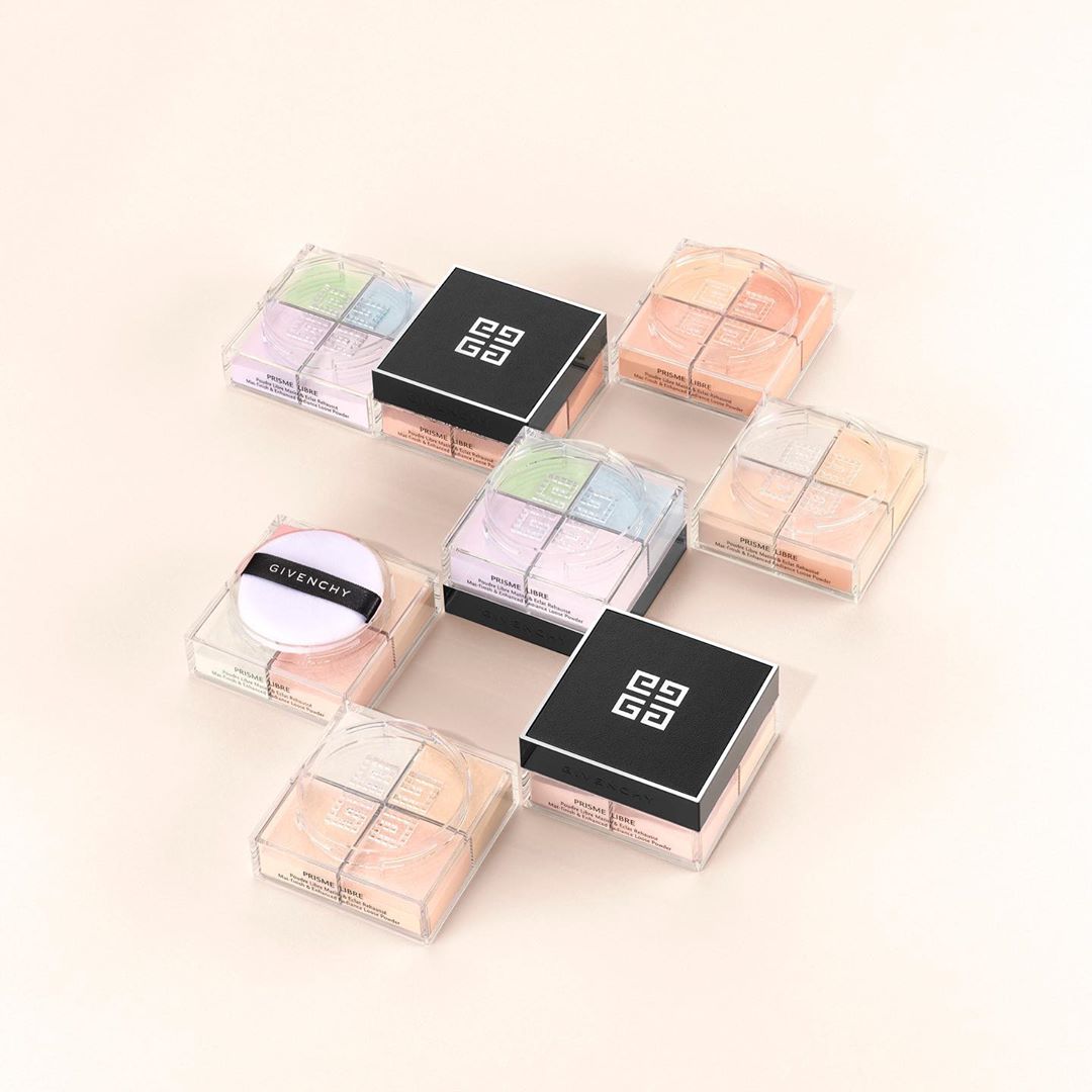 Arrangement of Givenchy Prisme Libre loose powder compacts in clear and black packaging, showcasing a luxury cosmetic product on beige.