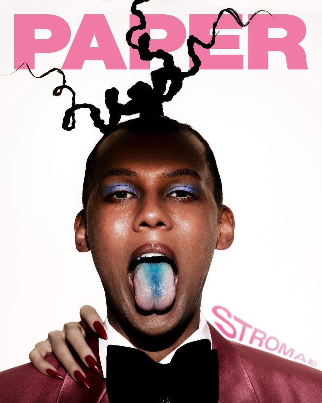Visie cover featuring a person wearing purple eye makeup and a blue tongue, with PAPER magazine logo at the top in pink.
