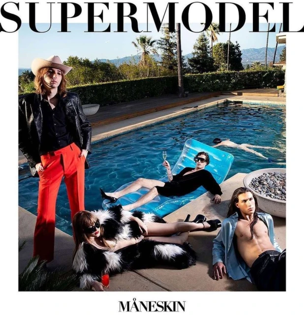 Group of fashion models near a pool, with one floating on a raft, dressed in stylish outfits, surrounded by trees and blue water.