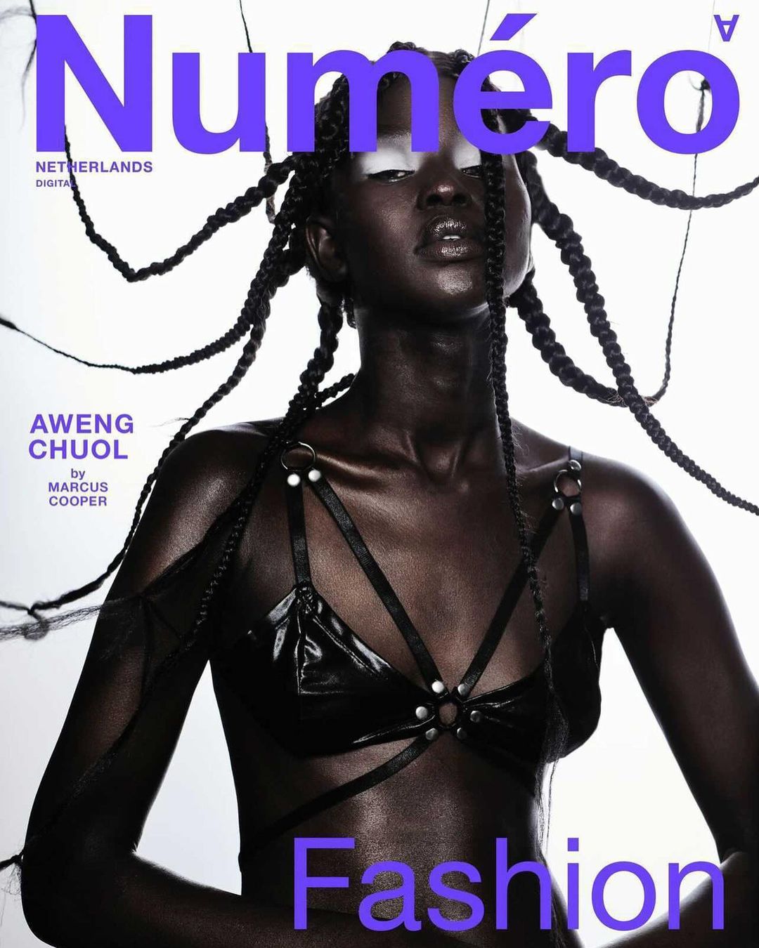 Fashion magazine cover featuring a Black woman with braids wearing a black bra with straps against a light background. The magazine title is "Numéro".