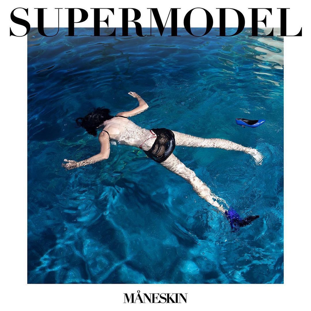 Woman in black swimsuit floats in turquoise water with swim fins. Maneskin logo at bottom and SUPERMODEL text on top.