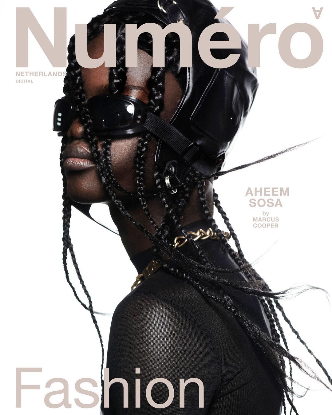 Fashion magazine cover featuring a Black model wearing a black leather aviator cap and sunglasses against a clean white backdrop.