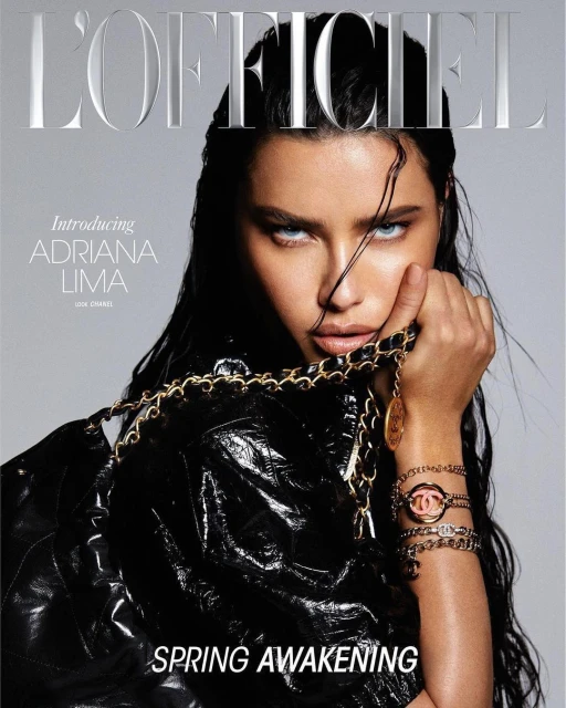 Adriana Lima on L'Officiel Magazine Cover in a wet hair look and black leather jacket, holding a gold Chanel chain and wearing bracelets.