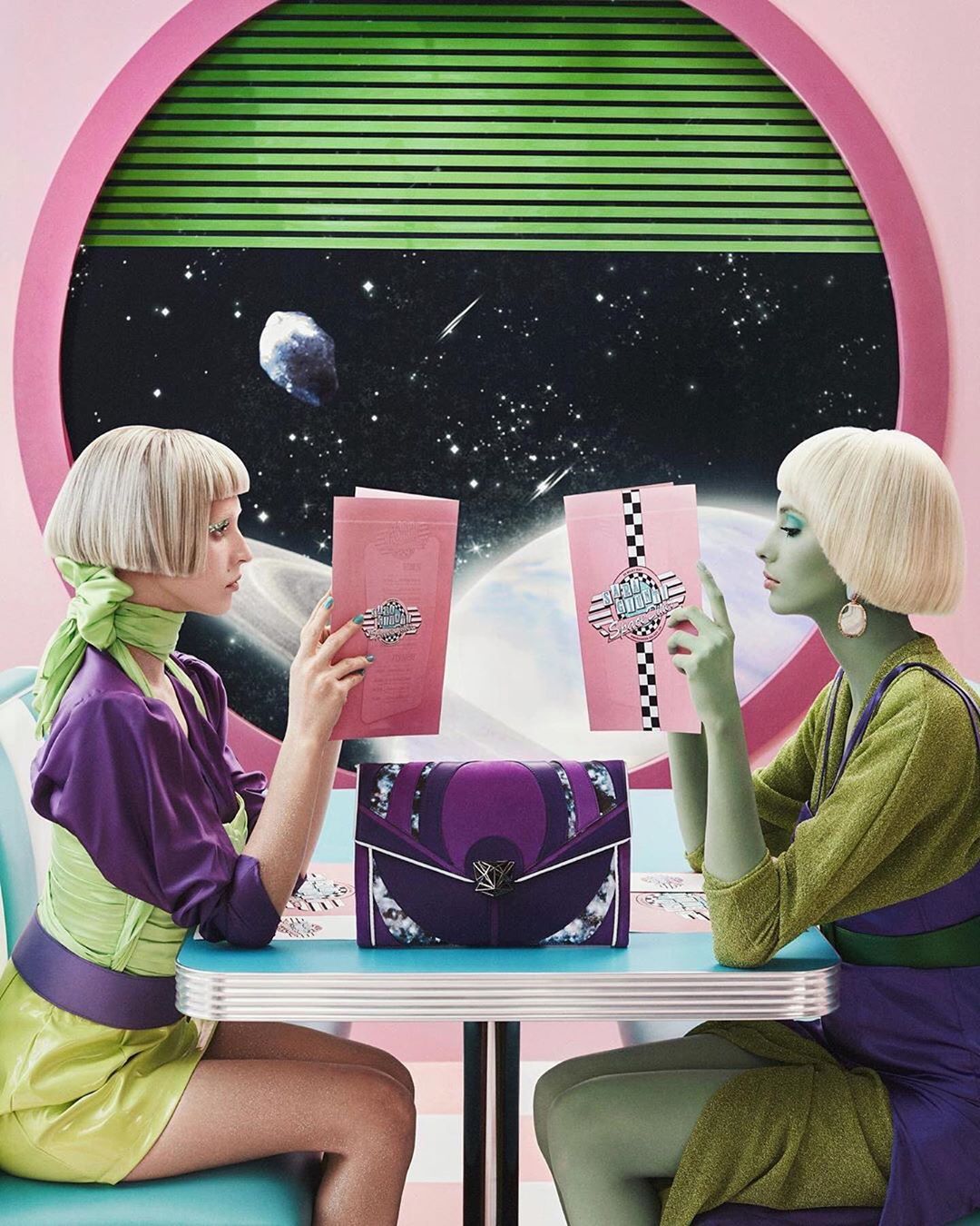 Two women at a diner-style table with menus and a handbag in a retro-futuristic setting with a cosmic backdrop and pastel colors.