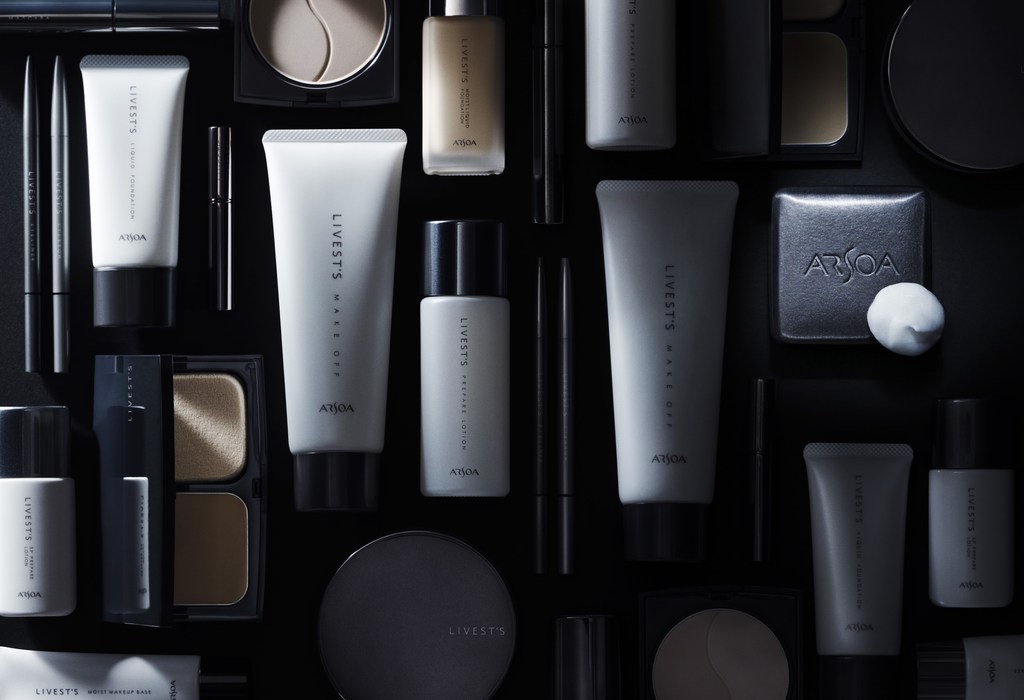 Flat lay of Livest's and Arsoa skincare and cosmetic products in white, gray, and black containers against a dark backdrop.