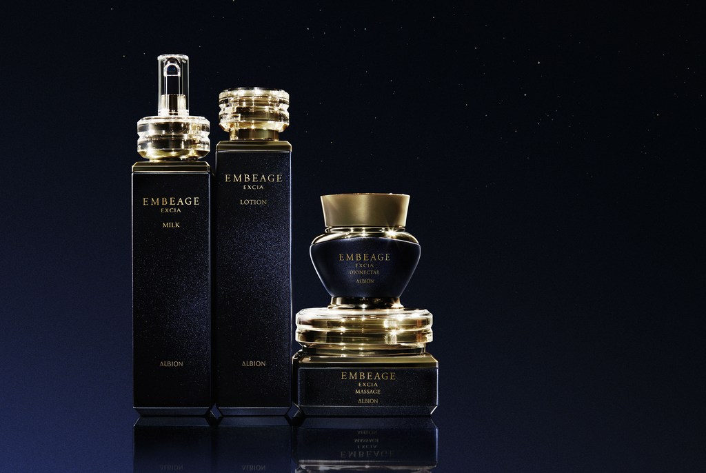 Luxury skincare product bottles in black and gold tones, including lotion, milk, and massage cream from Embeage Excia Albion brand.