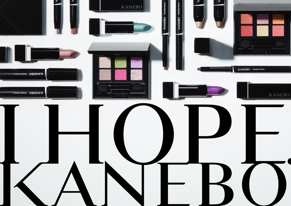 Kanebo makeup products: lipsticks, eye shadow palettes, and drawing pencils are arranged on a white surface with brand typography.