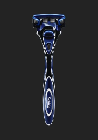 Close-up studio shot of a blue and black Schick razor against a dark background, highlighting the razor's design and features.