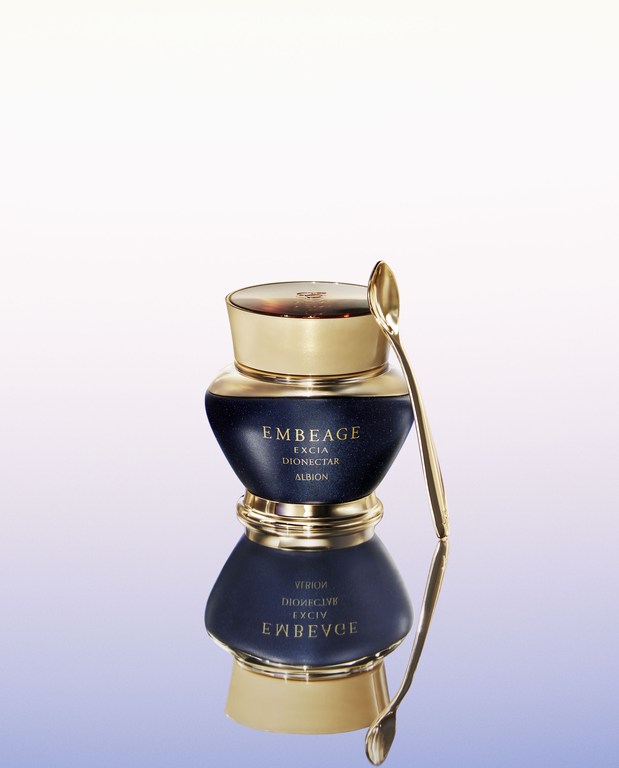 Cosmetic product EMBEAGE EXCIA DIONECTAR ALBION in dark blue and gold container with small golden spoon. Beauty and skincare.