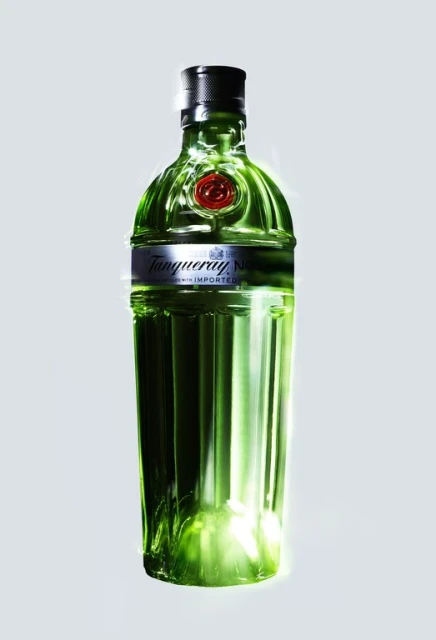 Green Tanqueray gin bottle isolated on a pale background, product shot with a clear glass texture and black cap detail.